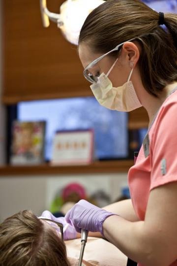 Dental Hygenist Performing a Teeth Cleaning